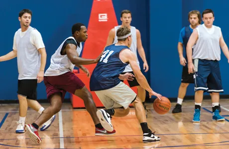 Adults playing basketball