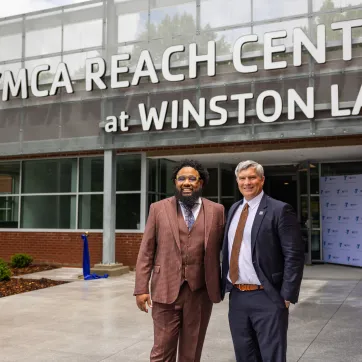 kenneth pettigrew and darryl head infront of newly opened YMCA REACH Center at Winston Lake
