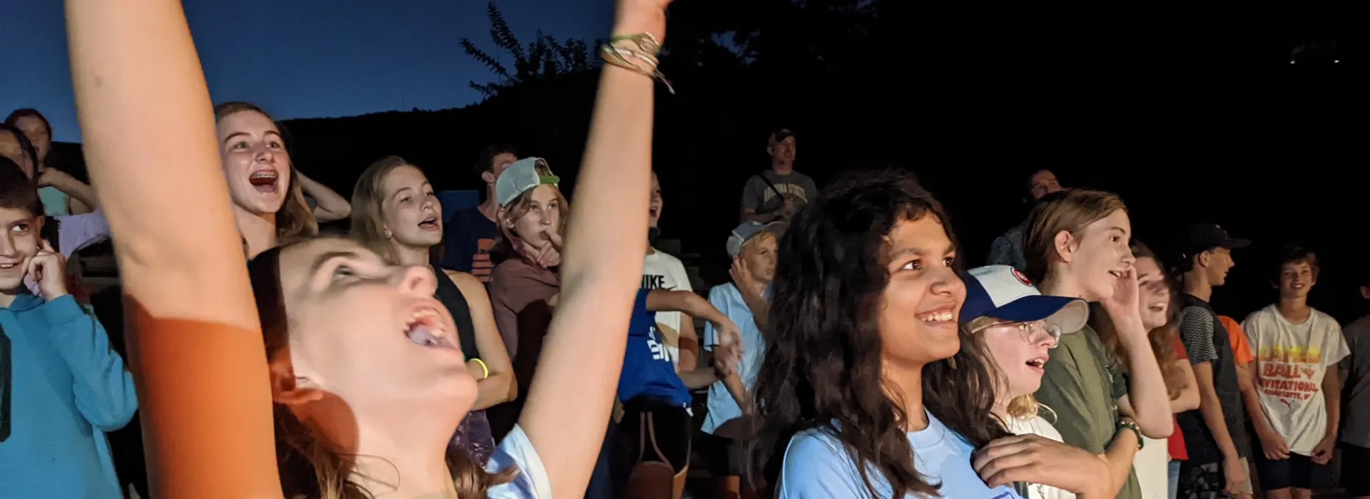 Kids laughing at camp fire